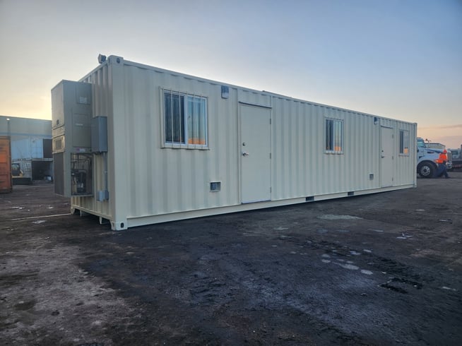 40 foot white shipping container modified into a jobsite office with windows, doors and electrical
