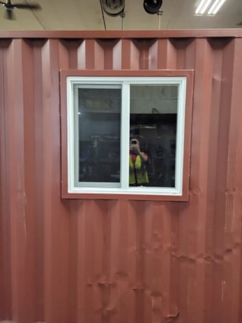 3 foot window installed on red shipping container