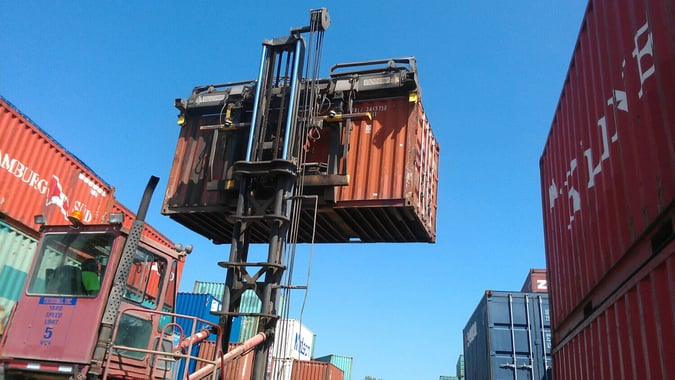 Container forklifts pick up 20's and 40's from the top corner posts