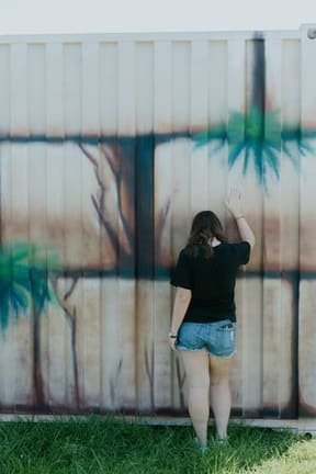 A young woman poses at the “Western Wall” section of the almost finished “Unity Art Sukkah” that now sits on the Chabad Jewish Center’s 9.6 acre  property that will be developed incrementally as the community grows.  Credit: Chabad Jewish Center of S