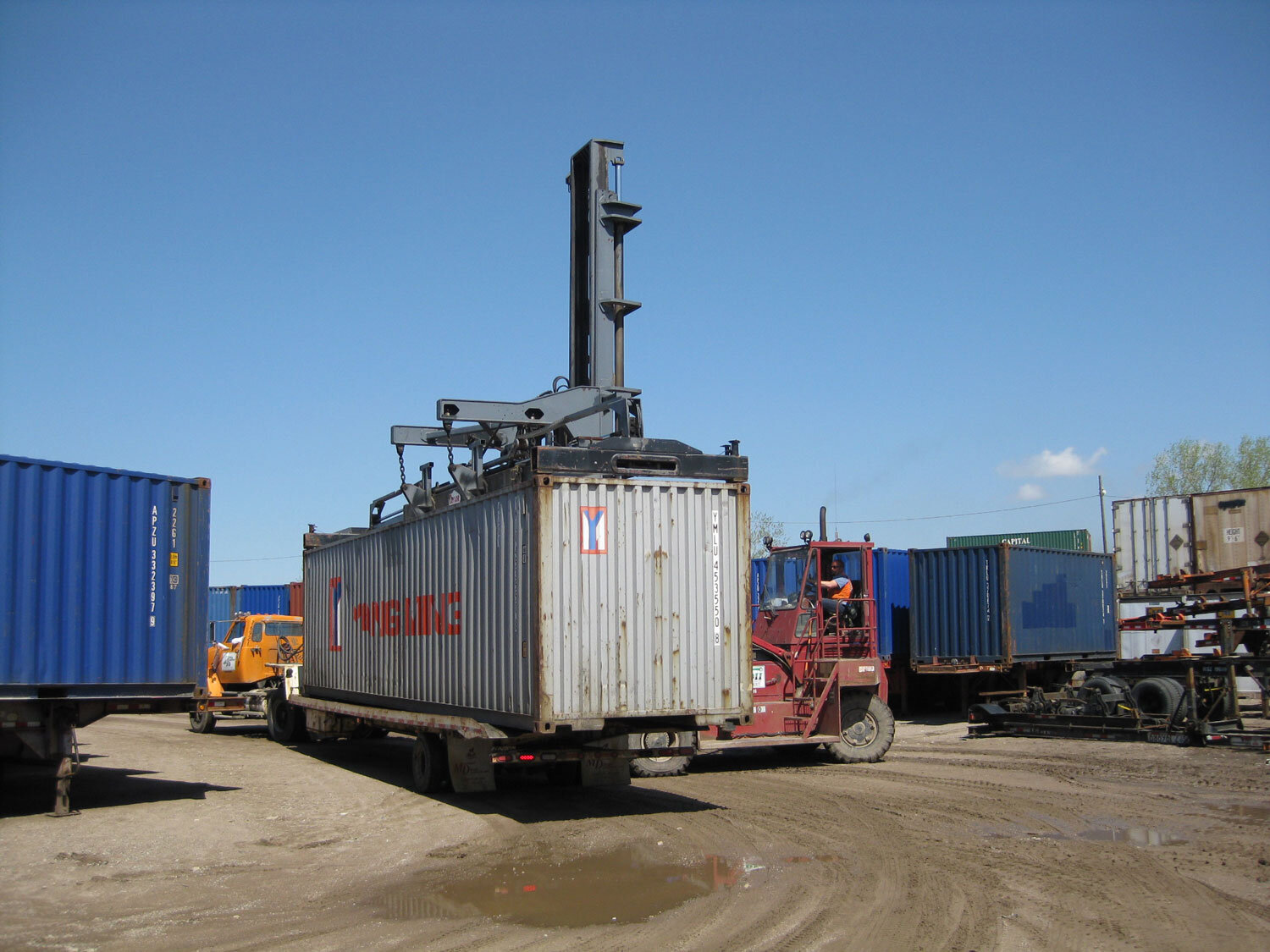 Cranes can load the container on a flat-bed or chassis