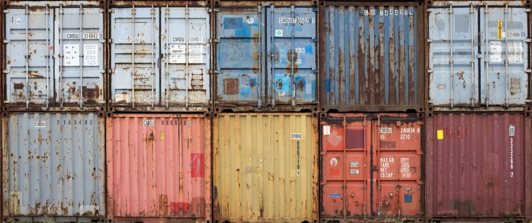 stack of colorful rusty shipping containers