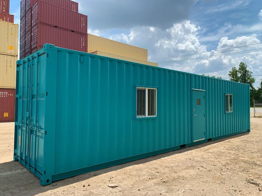 teal shipping container with window and door modifications
