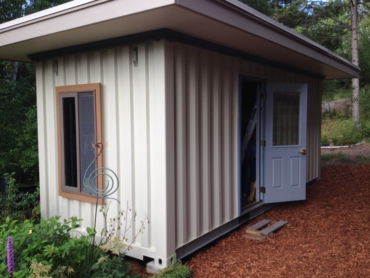 painted shipping container turned into a storage shed