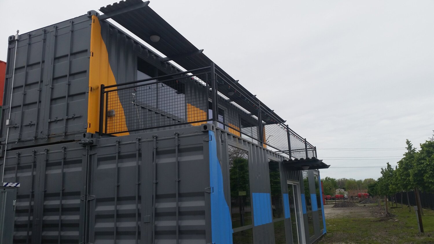 three black shipping containers made into a building