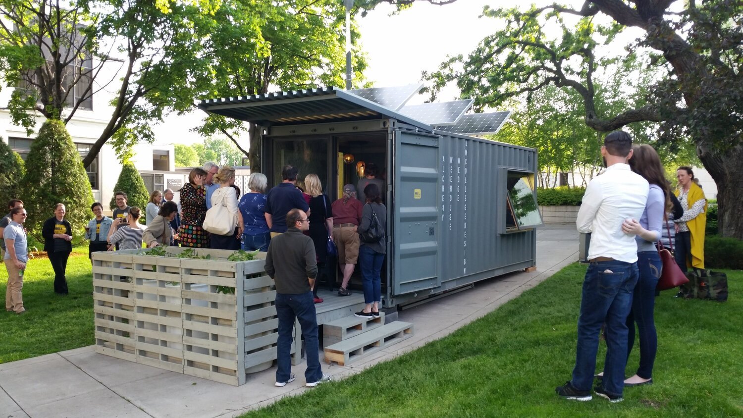 shipping container converted to hotel room with open door on end