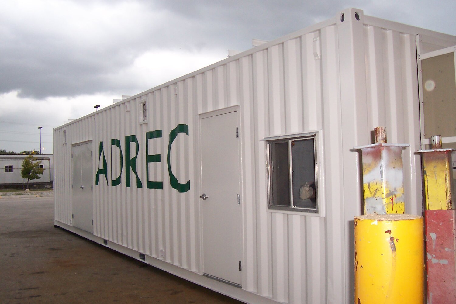  a white shipping container with a door and window modification