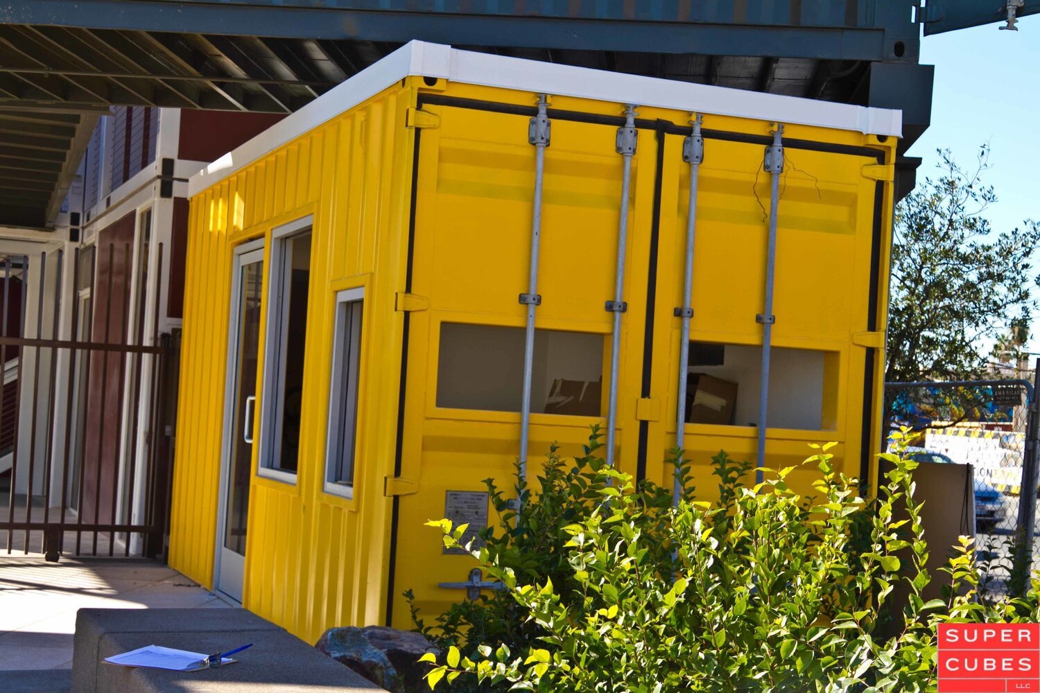 a bright yellow painted container turned into a home