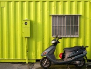 a lime green container with moped in front