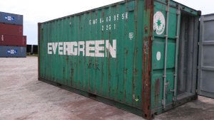 green shipping container with some rust spots