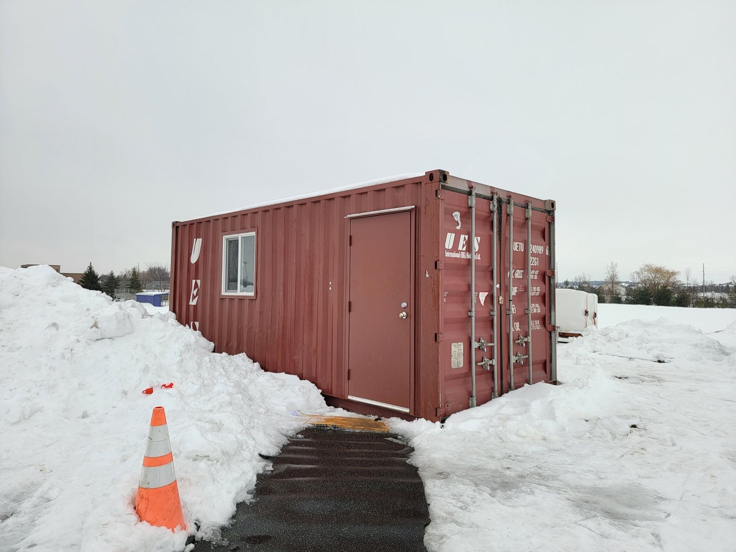 20' container converted to hockey warming house with door and window
