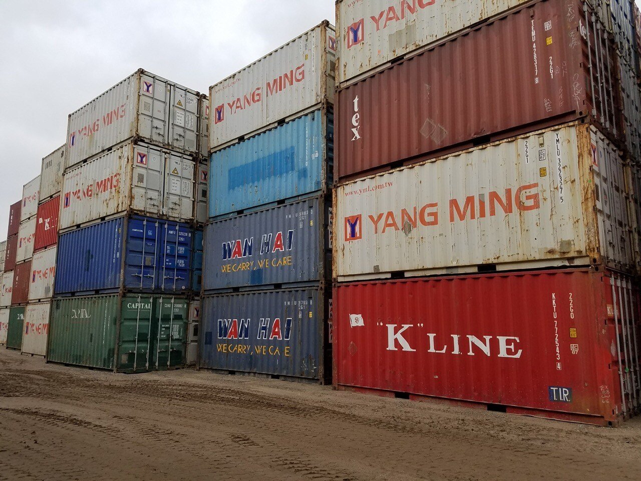 stacks of colorful used shipping containers